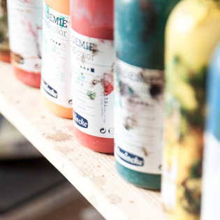 Container of paint on a shelf.